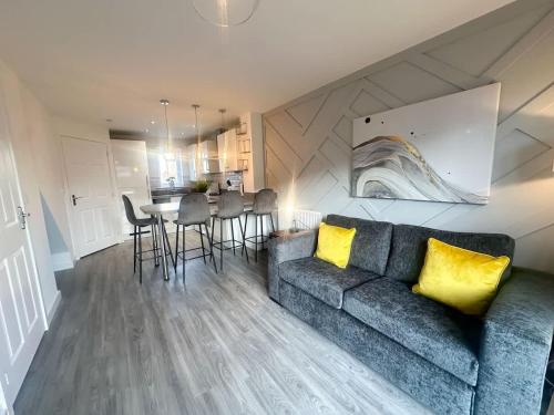 a living room with a couch and a table at Ruby Place by Blue Skies Stays in Hartlepool