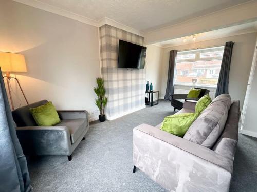 a living room with two couches and a television at Corfe House by Blue Skies Stays in Stockton-on-Tees