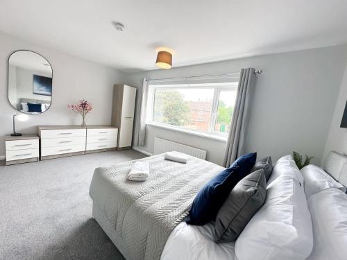 a bedroom with a bed and a large window at Corfe House by Blue Skies Stays in Stockton-on-Tees