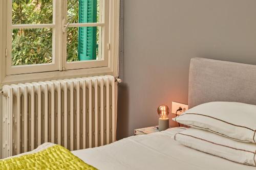 a bedroom with a radiator and a window at Beit Tamanna Guesthouse in Beirut