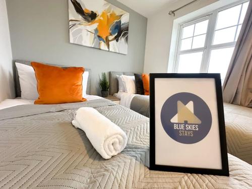 a bedroom with a bed with a framed sign on it at Edison House by Blue Skies Stays in Stockton-on-Tees