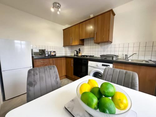 a kitchen with a bowl of fruit on a table at Edison House by Blue Skies Stays in Stockton-on-Tees
