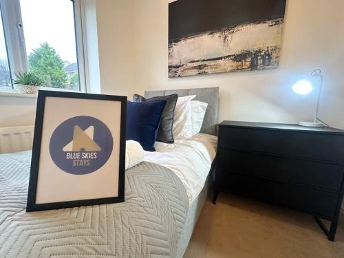 a bedroom with a bed with a sign on it at Wharf House by Blue Skies Stays in Stockton-on-Tees