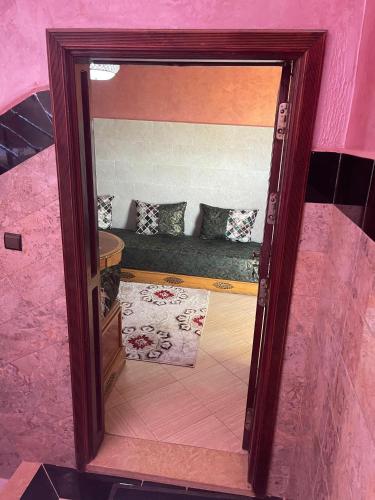 a doorway to a room with a couch in a pink room at اقامة قرب حمام my yaacup in Moulay Yacoub