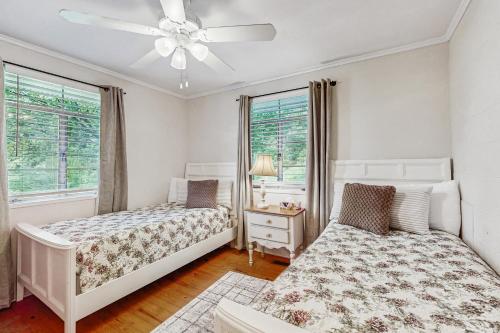 una camera da letto con due letti e un ventilatore a soffitto di Lake Chatuge Cottage a Hiawassee