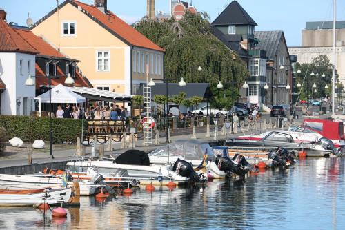 a group of boats are docked in a harbor at Åhus Gästgivaregård in Åhus