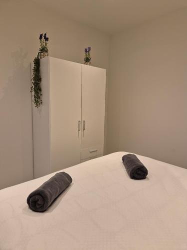 a bedroom with a bed with two pillows on it at Huis ALNA 6 in Mechelen