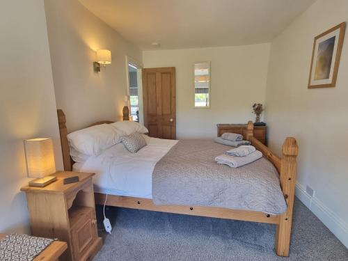 a bedroom with two twin beds and a night stand at Moelwyn View Cottage in Blaenau-Ffestiniog