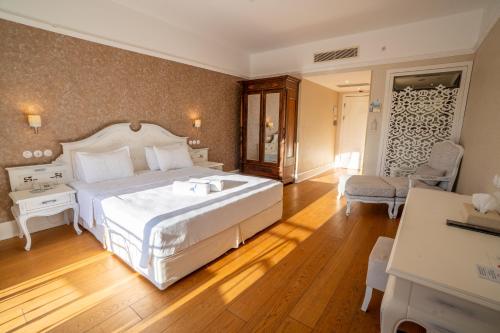 a bedroom with a large white bed in a room at Antmare Hotel in Alacati