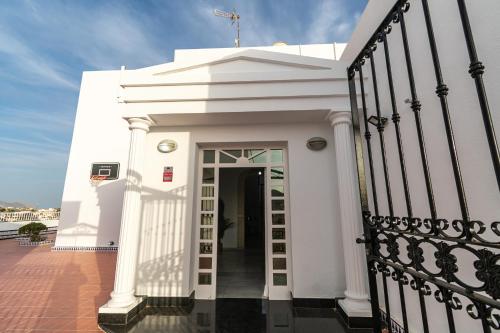 a white building with a door and a staircase at Villa Nico - By Aloha Palma in Águilas