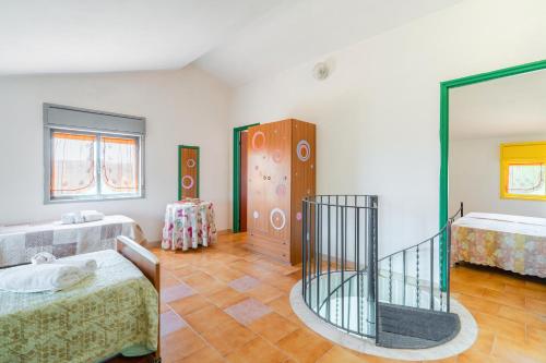 a large room with two beds and a mirror at La quiete della campagna in Noto