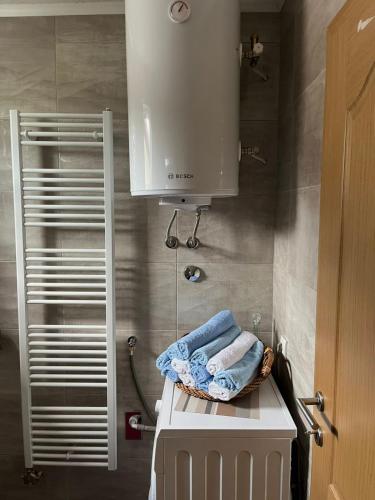 a kitchen with a sink and a cabinet and towels at Home in Sarajevo in Doglodi