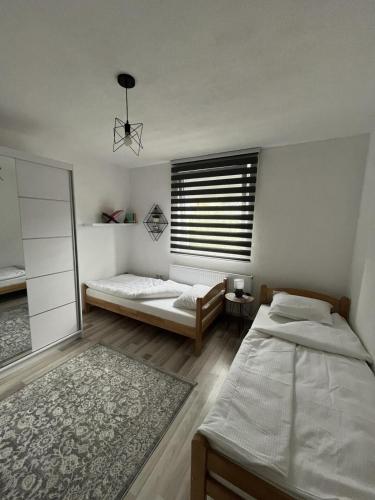 a bedroom with two beds and a window at Home in Sarajevo in Doglodi