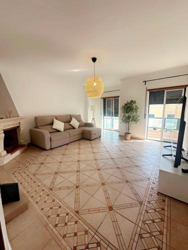 a living room with a couch and a fireplace at Elegant Getaway II - Lisbon- 2 bedroom apartment in Montijo in Atalaia