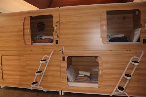 a wooden room with two ladders in it at SOPO Backpackers in Gold Coast