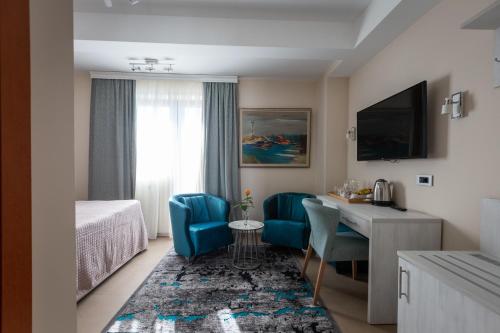 a hotel room with a bed and a table and chairs at Apollonia Hotel Gevgelija in Gevgelija