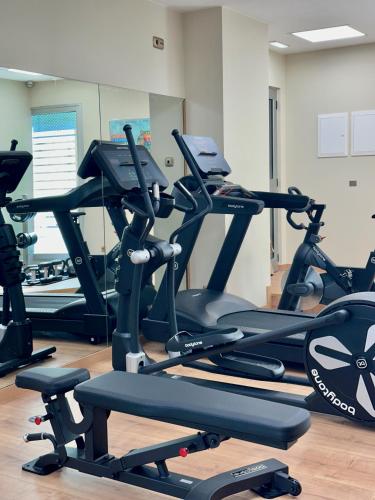 a gym with several tread machines in a room at Silken Reino de Aragón in Zaragoza