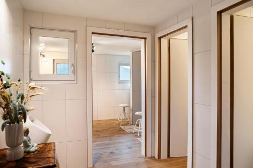 a bathroom with white walls and a doorway at Berghof Moosen in Hart im Zillertal