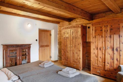a bedroom with a bed and wooden walls at Berghof Moosen in Hart im Zillertal