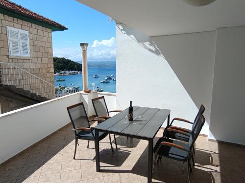 a table and chairs on a balcony with a view of the ocean at Vanda Seafront Superior in Cavtat