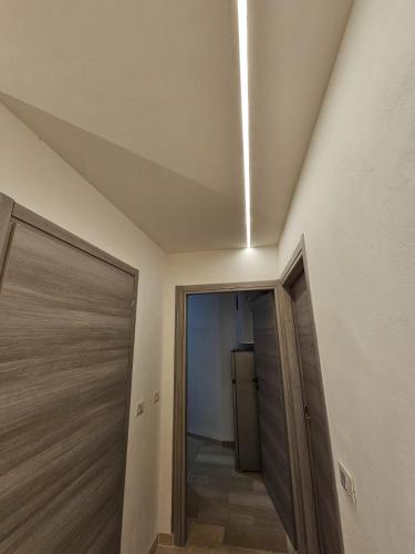 a room with a ceiling with a door and a refrigerator at MareMy Vasto Centro in Vasto