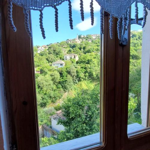 a window with a view of a mountain at Jona Guest house in Gjirokastër