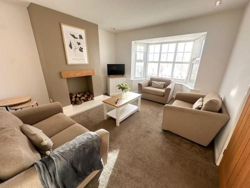 a living room with two couches and a fire place at Carew Place by Blue Skies Stays in Seaton Carew