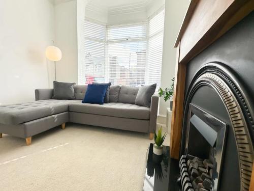 a living room with a couch and a tv at Wrightson House by Blue Skies Stays in Stockton-on-Tees