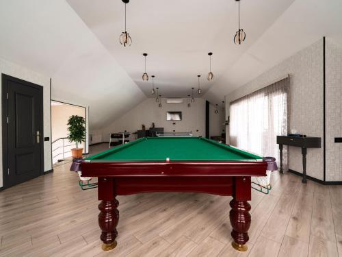 a pool table in the middle of a room at Twin Villas Gabala in Gabala