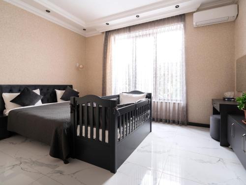 a bedroom with a bed and a large window at Twin Villas Gabala in Gabala