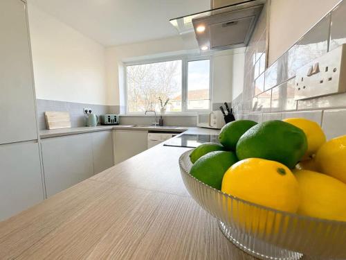 a kitchen with a bowl of fruit on a table at York House by Blue Skies Stays in Stockton-on-Tees