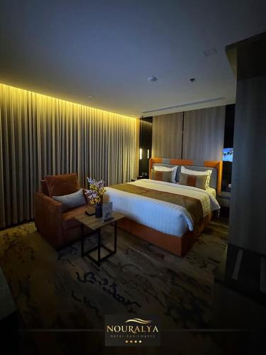 a hotel room with a large bed and a couch at شقق نوراليا للشقق المخدومة in Al Khobar