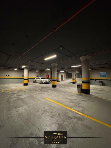a parking lot with a car in a parking garage at شقق نوراليا للشقق المخدومة in Al Khobar
