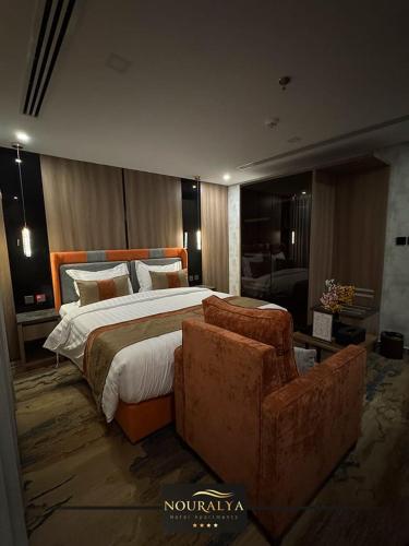 a bedroom with a large bed and a couch at شقق نوراليا للشقق المخدومة in Al Khobar