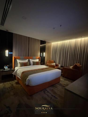 a large bedroom with a large bed and a couch at شقق نوراليا للشقق المخدومة in Al Khobar