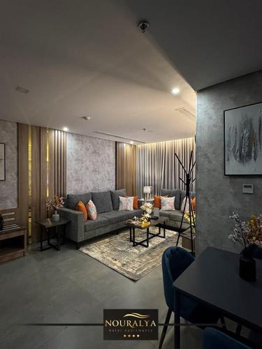 a living room with a couch and a table at شقق نوراليا للشقق المخدومة in Al Khobar