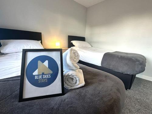 a hotel room with two beds and a sign on the bed at Letchworth House by Blue Skies Stays in Stockton-on-Tees