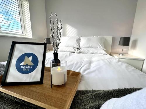 a bedroom with a bed with a candle on a table at Middlebeck House by Blue Skies Stays in Middlesbrough