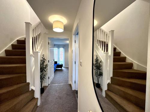 a hallway with stairs in a home with a mirror at Dale House by Blue Skies Stays in Middlesbrough