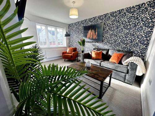 a living room with a couch and a table at Park House by Blue Skies Stays in Middlesbrough