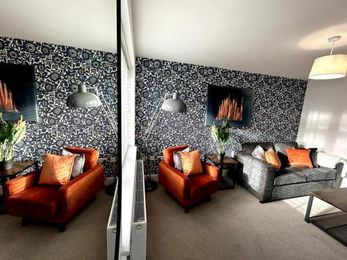 a living room with two chairs and a couch at Park House by Blue Skies Stays in Middlesbrough
