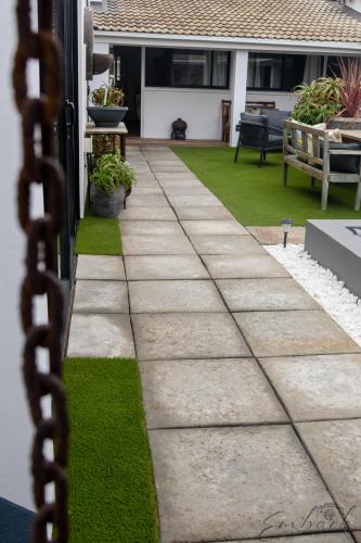 a patio with a chain in front of a house at The Rez Guesthouse in Walvis Bay