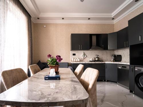 a kitchen and dining room with a table and chairs at Twin Villas Gabala in Gabala