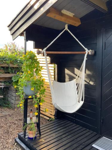a hammock hanging from awning on a wooden deck at Spiced Bed&Breakfast in Nykøbing Falster