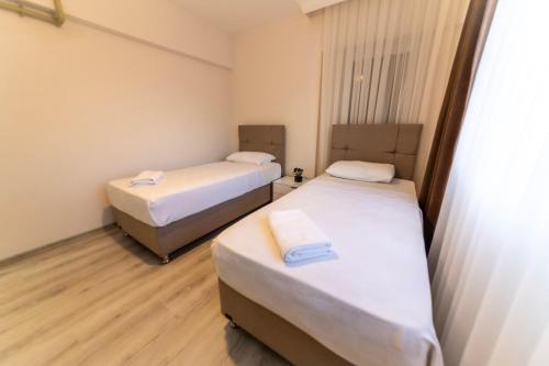 Katil atau katil-katil dalam bilik di Belya Apart Hotel