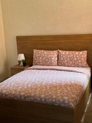 a bedroom with a large bed with two pillows at Julie Airport Marrakech Apartments in Marrakech