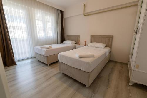 Katil atau katil-katil dalam bilik di Belya Apart Hotel