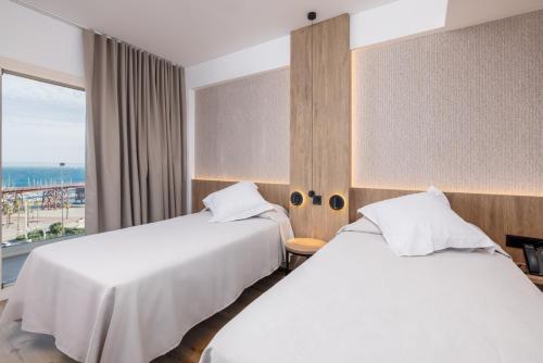 Ένα ή περισσότερα κρεβάτια σε δωμάτιο στο Ohtels Gran Hotel Almeria