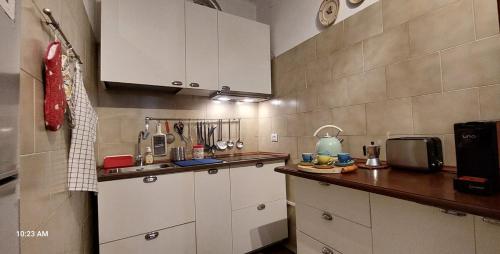 a kitchen with white cabinets and a counter top at Le Grazie by The Sea, Beachfront with elevator in Le Grazie