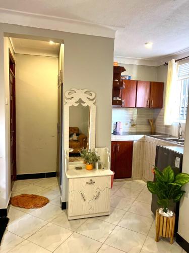a kitchen with a mirror and a table in it at Utopia B&B Kampala Uganda in Kampala